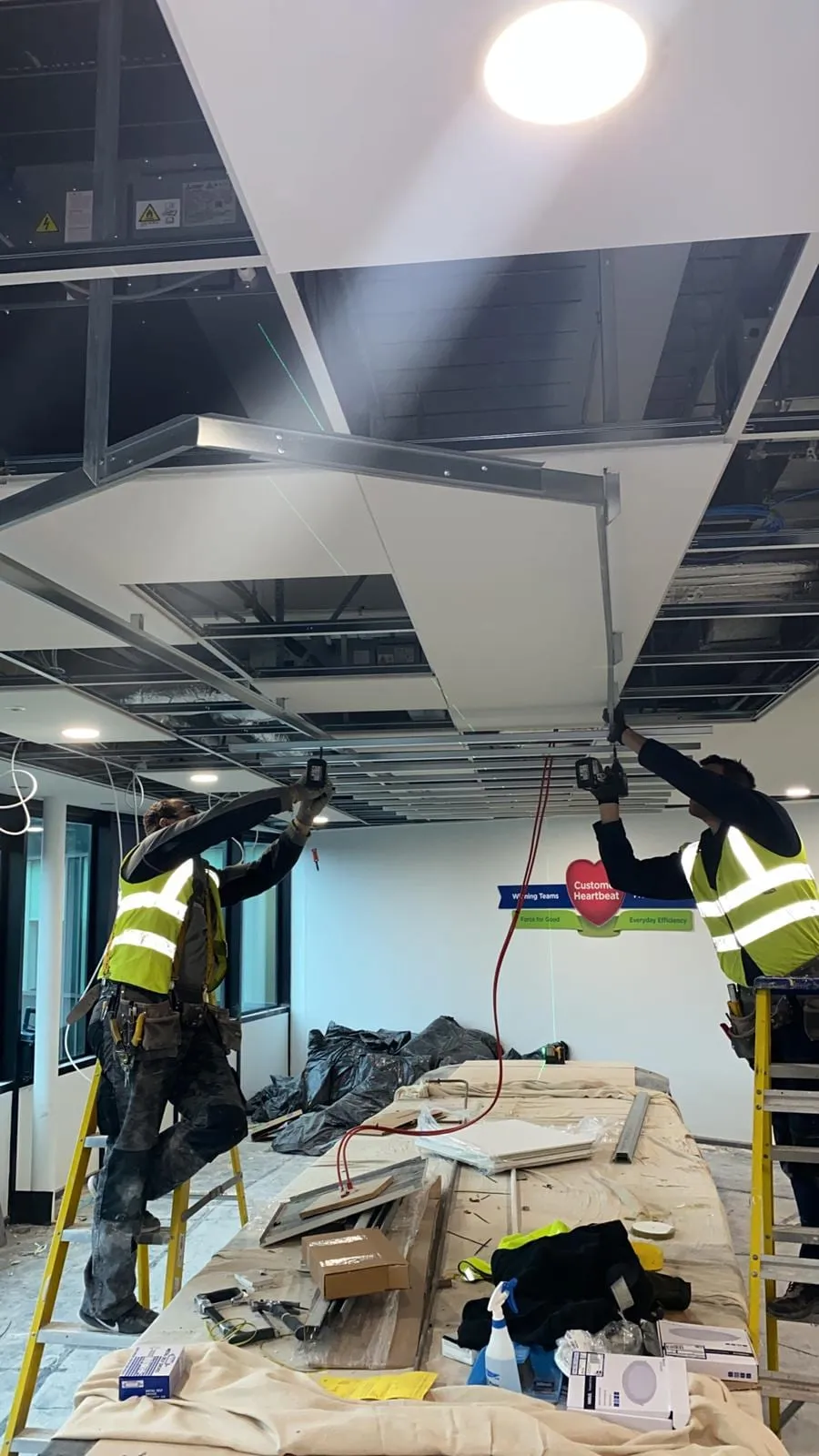 CMD Ceilings Ltd fitters installing a ceiling and partition framework